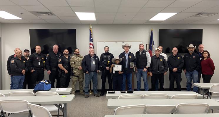 Members of the Austin County Sheriff's department welcome Devarjaye "DJ" Daniel as a new honorary deputy. 