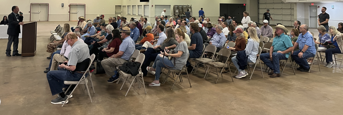 Austin County Judge Tim Lapham addresses a crowd of over 100 Austin County residents and stakeholders at a public hearing for a moratorium on data center and battery energy storage systems, Monday, July 13, at the Austin County Fairgrounds in Bellville. THE SEALY NEWS | ALLISON DRINNON