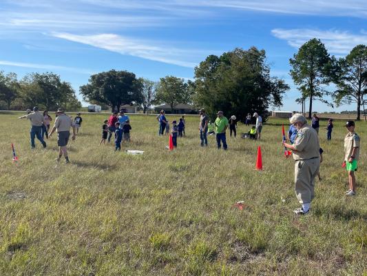 Coastal Plains District Advancement Chair Dr. Greg Stephens (right) assisting with launching a rocket during the District’s Rocket Day in Orchard.