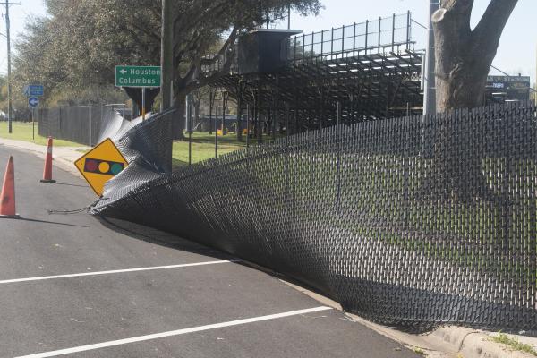 Heavy winds take down fencing around T.J. Mills Stadium.