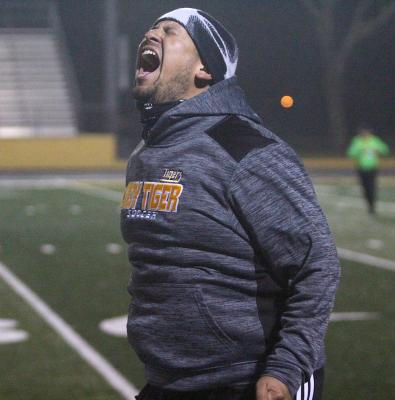 Lady Tiger soccer coach Adrian Rocha celebrates a goal
