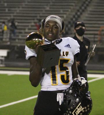 Sealy senior Draper Parker celebrates with the undefeated district championship trophy the Tigers won at Stingaree Stadium in Texas City, Nov. 6, 2020. COLE MCNANNA