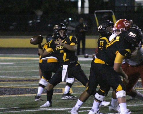 Sealy junior quarterback D'vonne Hmielewski loads up for a throw during the Tigers' non-district game against Stafford Friday at T.J. Mills Stadium. COLE McNANNA