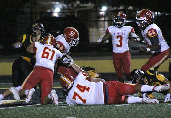 Stafford running back Jamaal Wiley backs his way into the end zone for his second touchdown to help the Spartans beat Sealy 28-14 Friday night at T.J. Mills Stadium. COLE McNANNA
