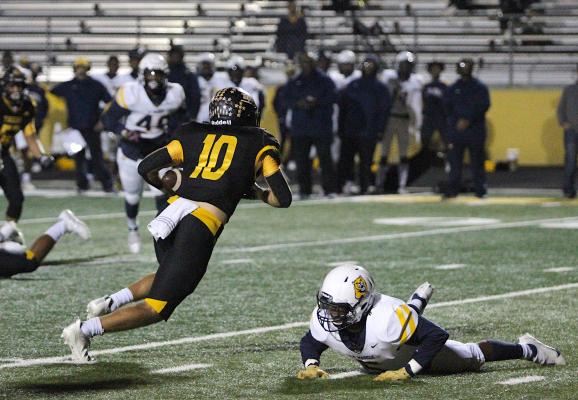 Tiger senior Thomas Clark secures a catch and avoids a would-be tackler during Sealy’s district game against La Marque Friday night at T.J. Mills Stadium. COLE McNANNA