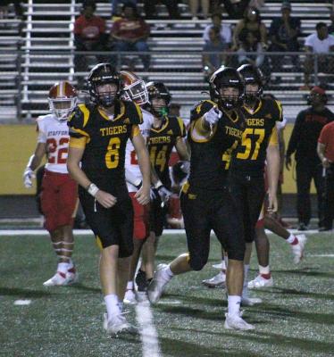 Sealy senior Connor Krenek points to the Tiger sideline after his blocked punt in the third quarter of the Tigers' non-district contest against Stafford Friday night in Sealy. COLE McNANNA