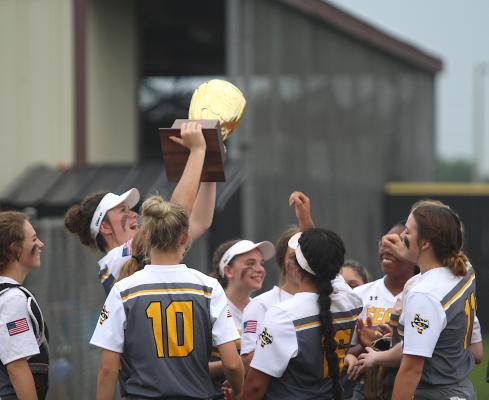 Sealy softball hoists its bi-district championship trophy