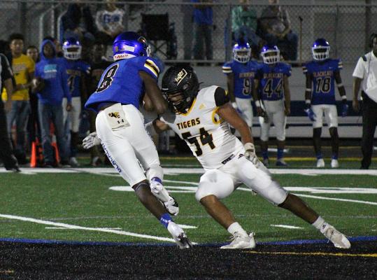 Tiger senior Jonathan Monterroza corrals Bay City's Jamorrious Abbott in the first half of Sealy's non-district finale on the road Friday night. COLE McNANNA