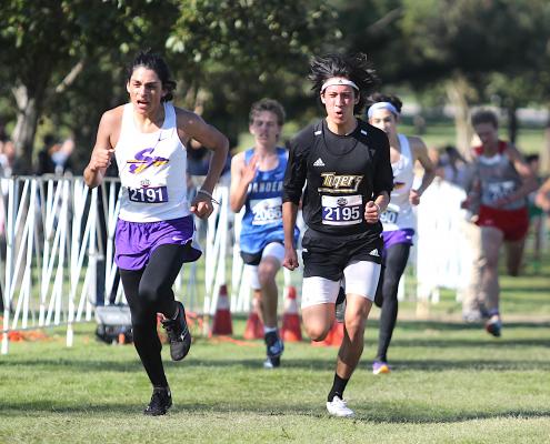 Sealy senior Daniel Medrano battles Sanger's Jose Rojas at the finish line of the Class 4A State Championship meet at Old Settlers Park in Round Rock. COLE McNANNA