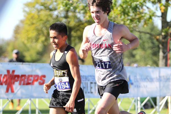 Tiger sophomore Fernando Garza builds an edge on Huffman's Finley Yoakum near the finish line of the course at Old Settlers Park during the Class 4A State Championship meet Saturday morning in Round Rock. COLE McNANNA