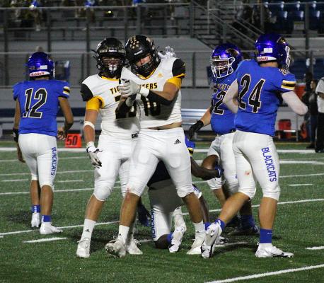 Sealy senior Thomas Clark celebrates a tackle in the first quarter of the Tigers' game against Bay City Friday night. He also supplied a 4-yard touchdown run on the night. COLE McNANNA