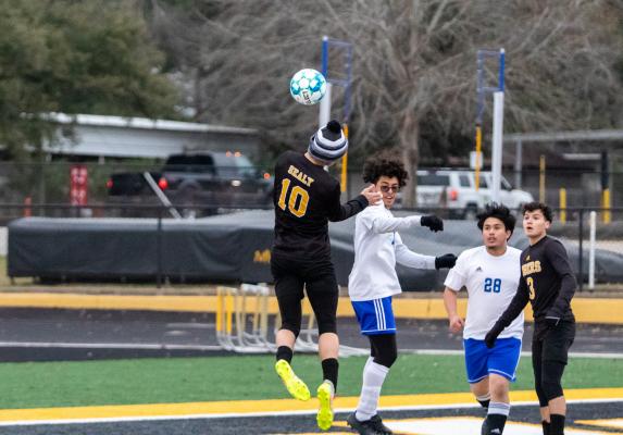 Tiger junior Tanner Ellis leaps for a header attempt during Sealy’s Feb. 25 district tilt against Discovery on Mark A. Chapman Field. Ellis was one of two first-team all-district representatives for the black and gold. COLE McNANNA