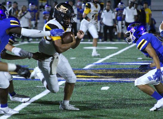 Tiger junior quarterback D'vonne Hmielewski finishes a run during the second half of Sealy's non-district finale against Bay City Friday night. Hmielewski added a short-yardage touchdown to the winning efforts. COLE McNANNA