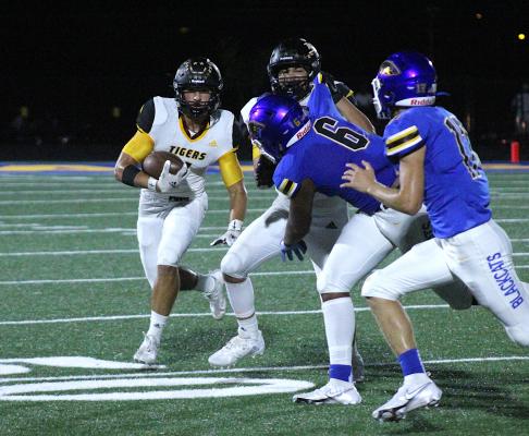 Tiger senior Connor Krenek looks to turn the corner on a run in the second half of Sealy's non-district finale against Bay City Friday night. COLE McNANNA