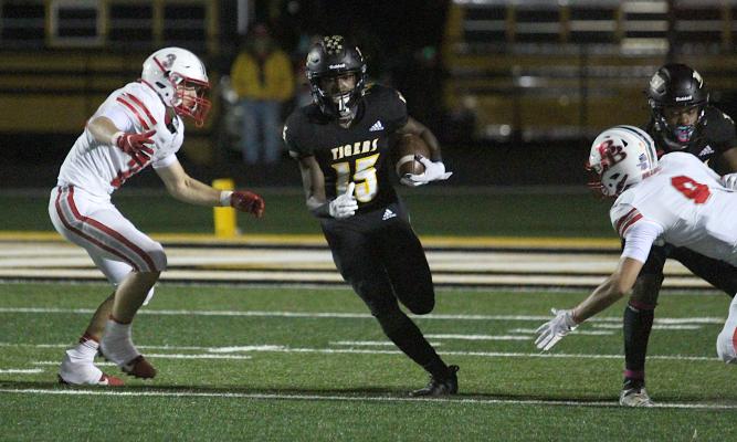 Tiger senior Draper Parker splits defenders during Sealy’s rivalry district contest against Bellville at T.J. Mills Stadium Oct. 16, 2020. COLE MCNANNA