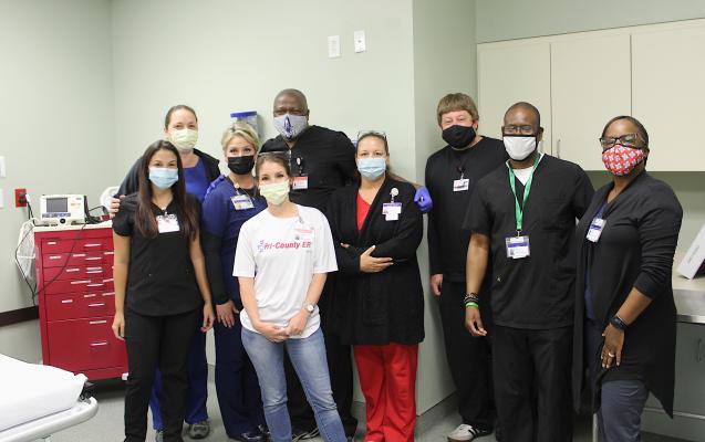 Tri-County ER staff celebrated its first anniversary with a celebration last Wednesday, May 12. Pictured from left to right are Robin Stiltner, Monica Dees, Marie Schobel, Renee Poulter, Melvin Foley, Robyn Schumann, Andrew Odinga, Ken Rhodes and Dr. Shawn Johnson. COLE McNANNA