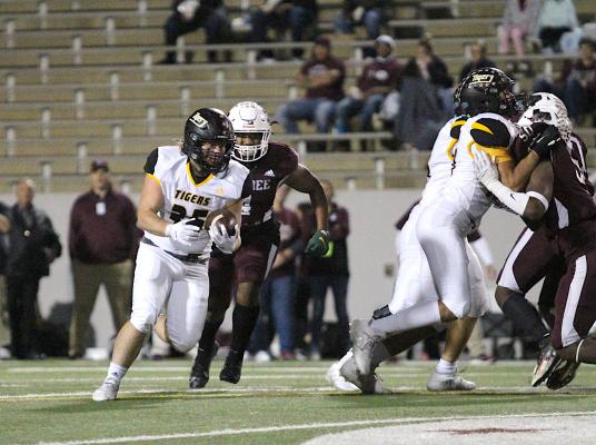 Tiger senior Ethan Hart turns the corner looking for the open field during Sealy's bi-district playoff game against Silsbee Friday in Aldine. COLE McNANNA