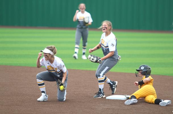 Sealy softball celebrates a caught stealing against Liberty in the playoffs.