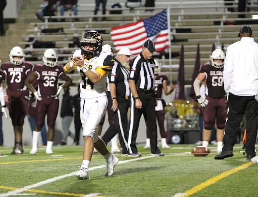 Sealy sophomore Jeffrey Neu celebrates one of the Tigers' red-zone stops as the officials measure a turnover on downs in the Bi-District Championship against Silsbee in Aldine Friday night. COLE McNANNA