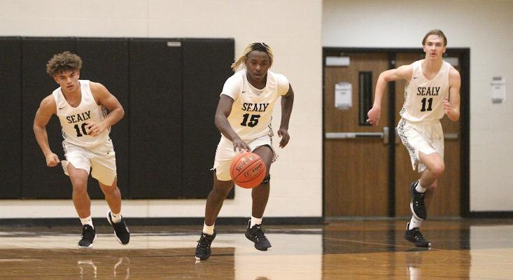 Sealy senior Draper Parker (15) leads the breakout from the Tigers' defensive end alongside classmate Jacob Gajewski (11) and sophomore D'vonne Hmielewski (10). COLE MCNANNA