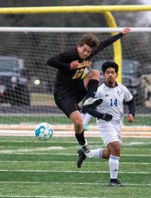 Tiger junior William Forrester leaps to make a play on the ball in the first half of Sealy’s finale game of the regular season March 11 against Royal at home. COLE McNANNA