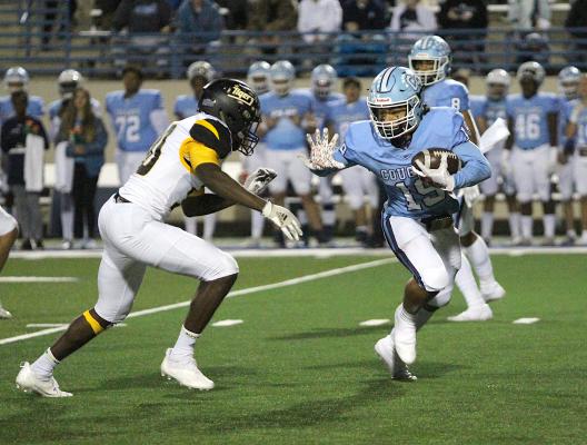 Tiger senior Myki Harris meets China Spring's Isaiah Williams in the backfield during the second-round playoff game at Waco ISD Stadium Friday night. COLE McNANNA