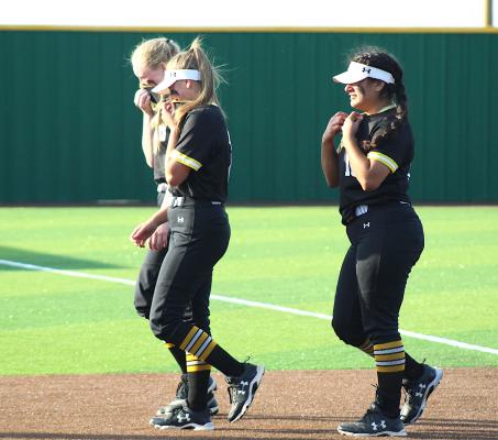 Sealy seniors Justice Jett, Brooke Kram and Kayla Camacho walk off the field together one last time after the Lady Tigers’ regional quarterfinal defeat to Liberty at Ira Floyd Field in Navasota last Friday. COLE McNANNA