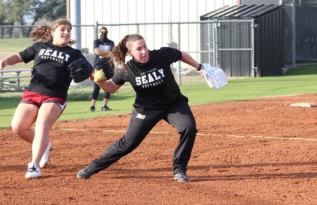Lady Tiger head softball coach Brittney Whitehead fields a bunt and looks to make the throw to first during Sealy’s intrasquad scrimmage last Friday afternoon. (Cole McNanna/Sealy News)