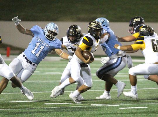 China Spring's Brayden Faulkner (11) bends around the corner and flushes Sealy's D'vonne Hmielewski (2) from the pocket in the second half of the Area Championship between the Cougars and Tigers at Waco ISD Stadium Friday night. COLE McNANNA