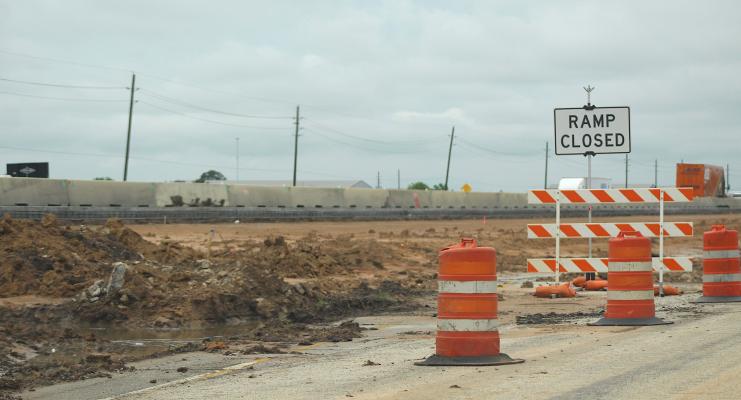 Barrels line the side of a frontage road near Beckendorff Road earlier in the day May 19. That night, a Sealy resident died in a wrong-way, single-car crash on a frontage road three miles west of Sealy. COLE McNANNA
