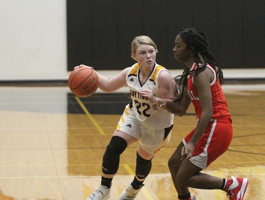 Sealy senior Megan Schaaf fends off a Royal defender during the Lady Tigers’ district contest against the Lady Falcons at home last Friday. Schaaf finished with six rebounds, five assists, four points, drew three charging fouls and added a steal. (Cole McNanna/Sealy News)