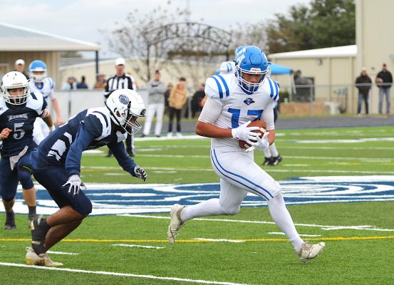 Knight senior Nathan Figueroa hauls in a pass in front of Northside senior Aidan Moorman during the battle for the TAIAO Division 2 state crown at Allen Academy’s Baker Field last Saturday.