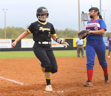 Sealy senior Brooke Kram scores one of the 10 runs the Lady Tigers pushed across in their big fourth inning during the district-opening game against Wharton at home last Tuesday morning. COLE McNANNA