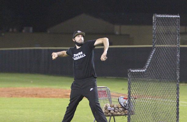 Tiger head baseball coach Dane Bennett throws batting practice during the first official tryout of the season last Friday night at Aubrey “Mutt” Stuessel Stadium in Sealy. (Cole McNanna/Sealy News)