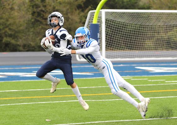 Faith Academy senior Maury Cano (20) makes a diving attempt to break up a pass intended for Northside freshman Sam Bonin (22) near the goal line in the first half of the TAIAO 6-man Division 2 State Championship at Baker Field in Bryan Saturday, Nov. 27. PHOTOS BY COLE McNANNA