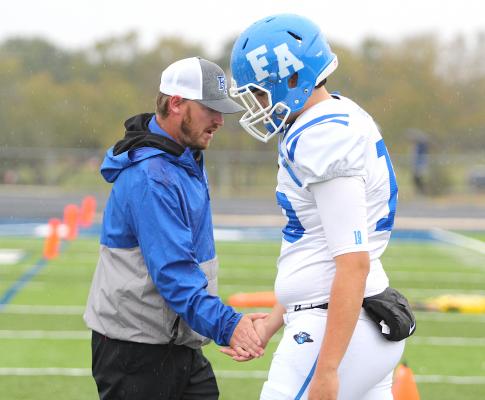 Faith Academy Head Football Coach Trey Carter high fives sophomore quarterback Noah Figueroa after the Knights’ defeat in the TAIAO Division 2 State Championship in Bryan Nov. 27.