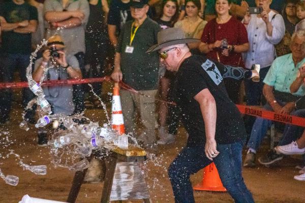 Jo Smith slices through water bottles during Saturday’s bracket-style chopping competition which he went on to win. COLE McNANNA