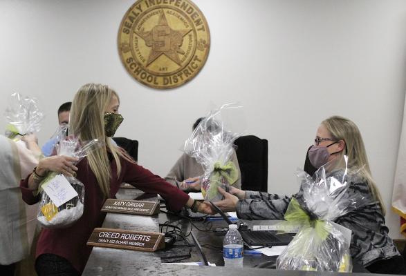 Sealy Elementary School Principal Sarah Winkelman presents a gift to Sealy ISD Board Vice President Katy Grigar as part of school board appreciation month during last Wednesday’s regular meeting at the Sealy ISD Administration Building. (Cole McNanna/Sealy News)
