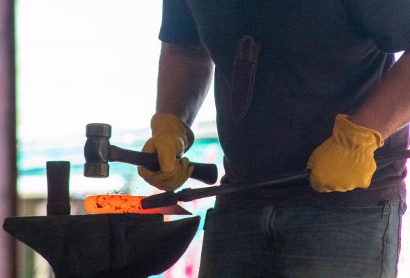Eric Thomas goes through a live forge on the main stage of the Texas Select event at the Austin County Fair Convention and Expo Center April 2. COLE McNANNA