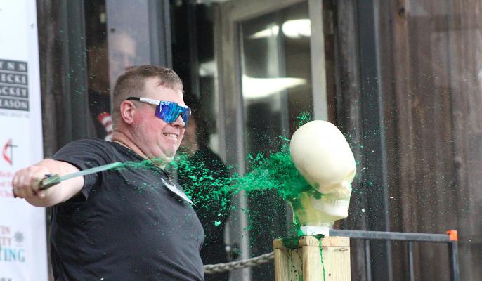 Jo Smith of Silver Anvil Blades cuts into a ballistic model of a head with a knife during a live demonstration at last weekend’s Texas Select from Forged in Fire event at Phenix Knives in downtown Bellville. (Cole McNanna/Sealy News)