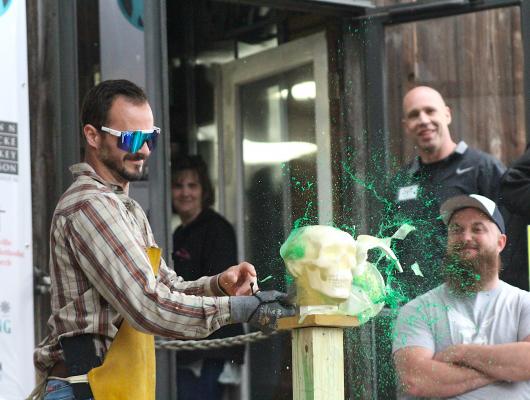 Alex Regusci won an auction item to have a shot at cutting into the ballistic head model at Texas Select from Forged in Fire event at Phenix Knives in downtown Bellville last Saturday. (Cole McNanna/Sealy News)