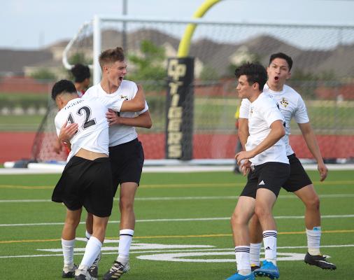 Tiger sophomore Tanner Ellis (10) celebrates the game-opening score with teammates Amador Lopez (12), Rodolpho Olivarez (3) and Ricky Avila (far right) during Sealy’s regional semifinal playoff game against Splendora last Tuesday at Cy Park High School. (Cole McNanna/Sealy News)