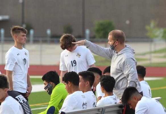 Coach Joshua Kirton confers with Sealy’s Tanner Ellis (10) on the sideline during halftime of the Tigers’ playoff game against Splendora at Cy Park High School April 6, 2021. Kirton assumed head coaching duties in the offseason and will open the season this weekend. COLE McNANNA