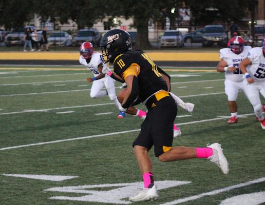 Tiger senior Thomas Clark hits the open field en route to a 45-yard interception returned for a touchdown on the second play from scrimmage during Sealy’s district-opening contest against Royal Friday night at T.J. Mills Stadium. COLE McNANNA
