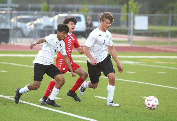 Sealy’s Max Requema (4) and William Forrester (7) separate a Splendora forward from the ball during the playoff game at Cy Park High School April 6, 2021. The pair of Tigers return to bolster this year’s squad with a bad taste in their mouths following the end of last season. COLE McNANNA