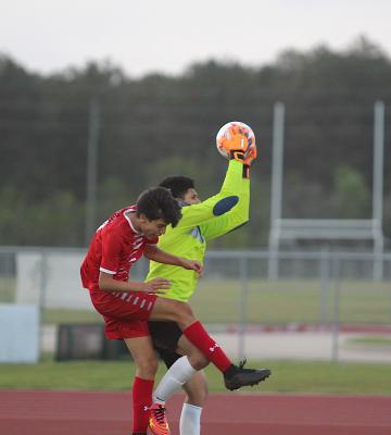 Tiger junior goalkeeper Brayan Aviles leaps up to secure a save against a Splendora attacker during the second half of the regional semifinal game at Cy Park High School in April. COLE McNANNA