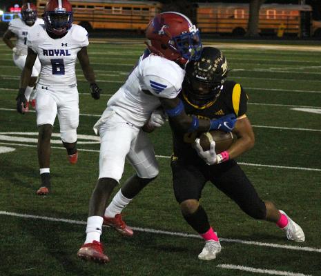 Sealy senior Connor Krenek drives a Royal defender for more yards after one of his eight catches Friday night that helped the Tigers beat Royal 26-0 to open district play Friday night at home. COLE McNANNA