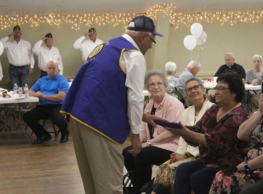 Current Sealy American Legion Commander Pete Berckenhoff presents a United States flag to Lenore Dronka in honor of her late husband Paul who passed away last Memorial Day during a celebration of life at the Columbus Hall Monday afternoon, May 31. COLE McNANNA