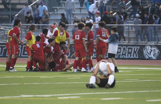 Sealy sophomore Angel Rodriguez buries his head while Splendora celebrates the regional semifinal victory they stole in the final minutes of regulation at Cy Park High School. COLE McNANNA