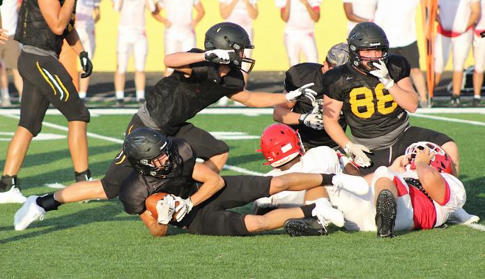 After a cloud of dust settled, the Tiger defense came up with a loose ball in the first portion of the Columbus scrimmage last Thursday at home. COLE MCNANNA